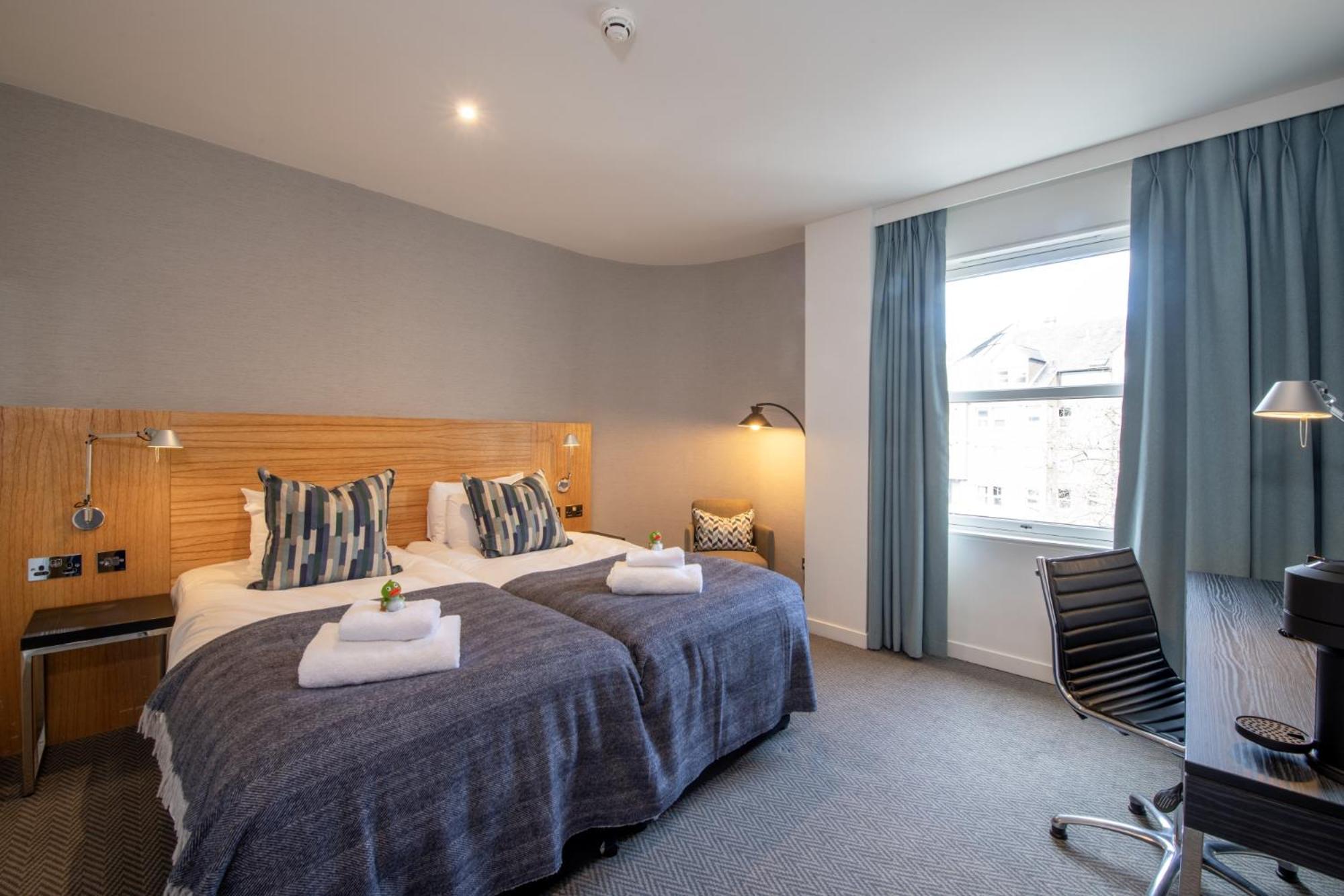 Kamer met twee aparte bedden met uitzicht op het kasteel